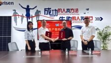 Photo of the two parties signing the agreement